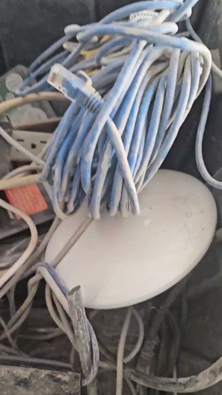 A bin of AV cables and wifi gear