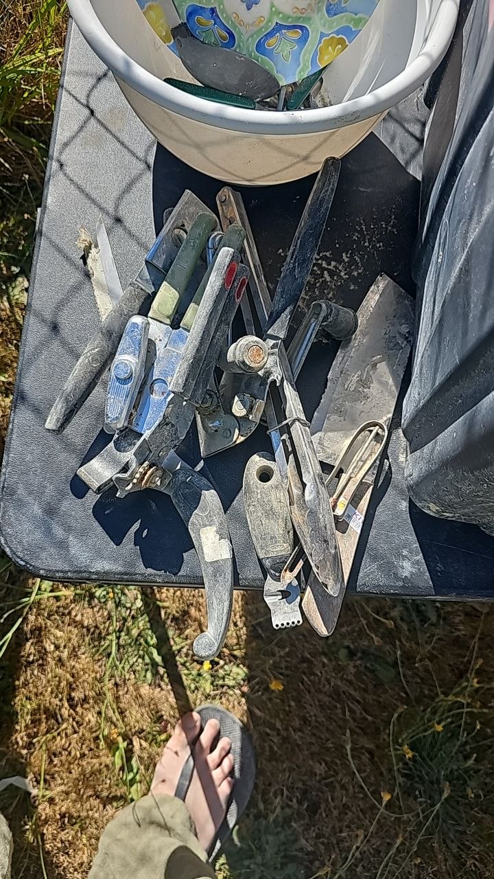 A pile of can openers and kitchen utensils