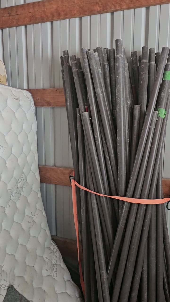 Carport poles bundled in the barn