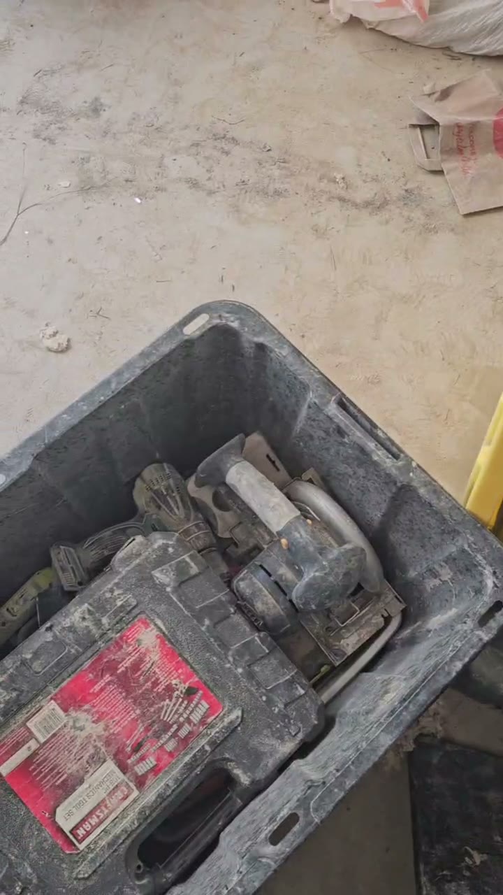 A bin of power drills and a circular saw