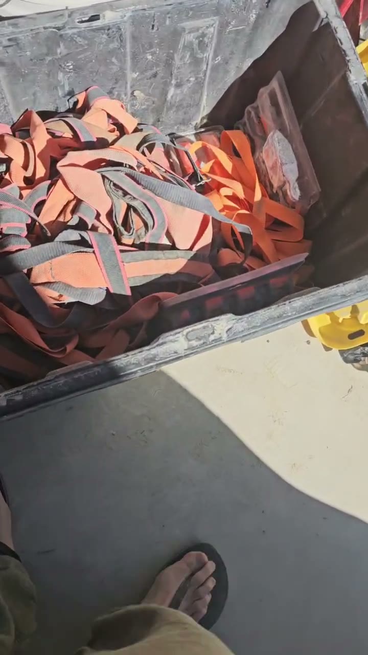 A tote overflowing with ratchet straps