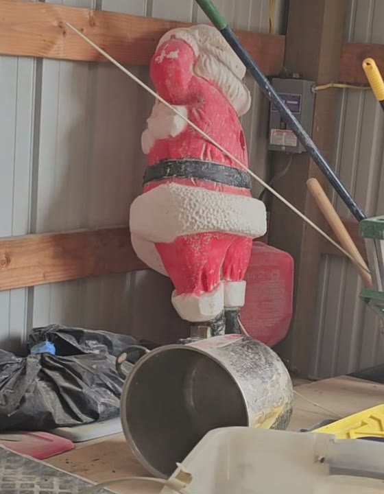 Close-up of the dusty blow-mold Santa figure in the barn